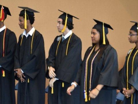 Image of trio students in graduation attire